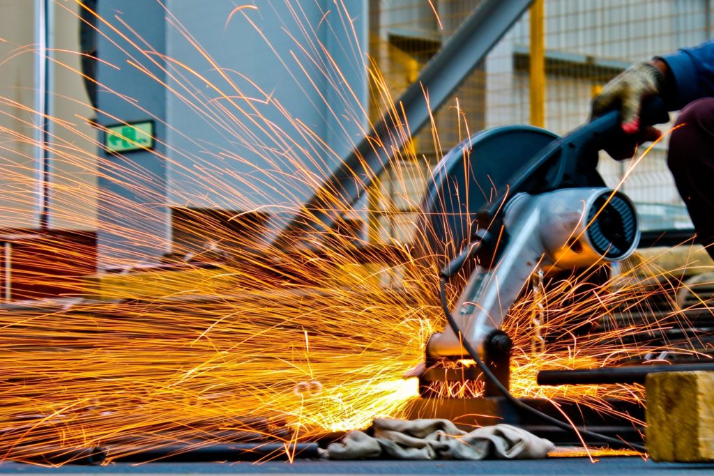Metal cutting in a workshop with sparks around the cutting disc