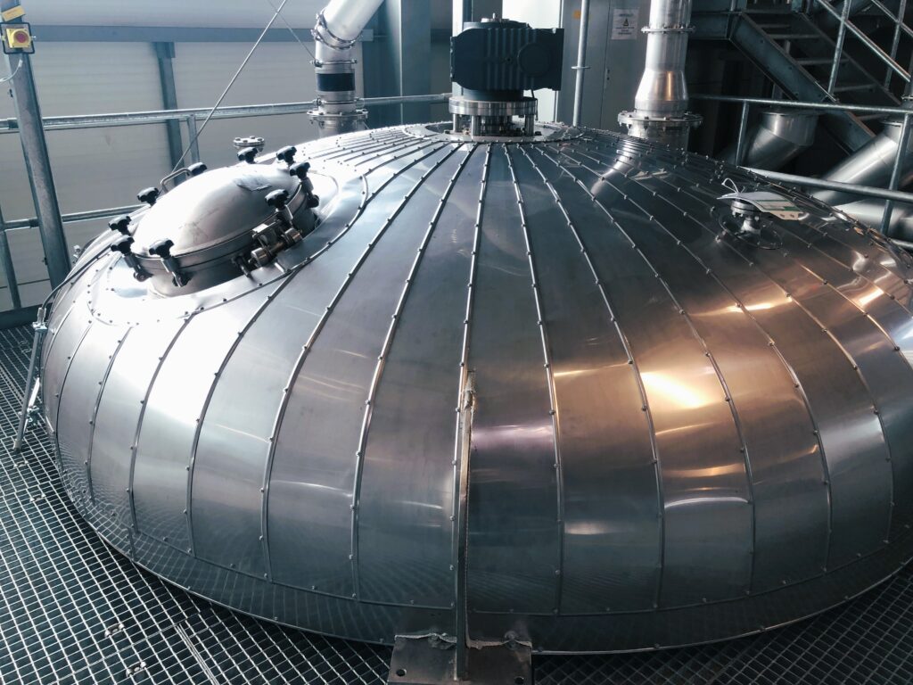 Protective metal insulation cladding around a large industrial vessel
